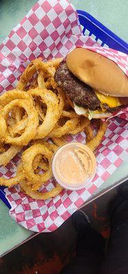 Hand pattied bacon cheeseburger with homemade onion rings.