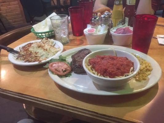 Steak with a side of spaghetti and hash browns. A quirky combo.