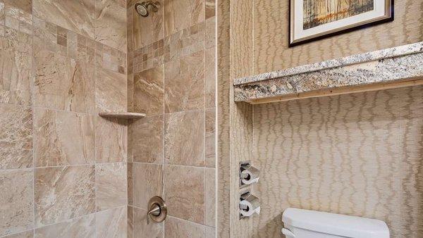 bathroom with shower and vanity