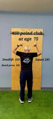 Earned his shirt at 75 years old with over 650 pounds between the deadlift, squat, and bench press