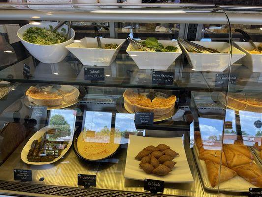 Salad, Tabouli, Penne Florentine, Kale Quinoa, Spinach and Tomato Quiche, Dolmades, & Hummus.