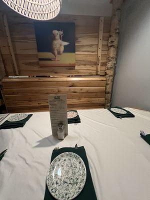 Dining booth-featuring Birch decor and whimsical art, has both open and more private seating.