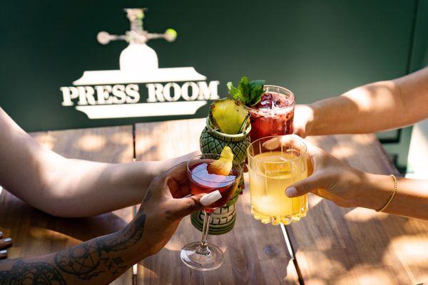 Friends cheers with summer cocktails