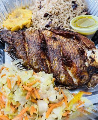 Fried Tilapia fish with Haitian rice, steamed cabbage and fried plantains