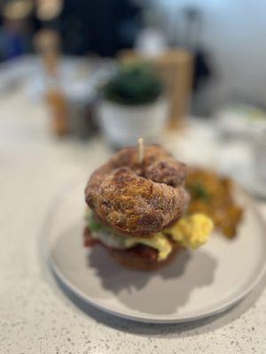 Cinnamon roll sandwich, scrambled eggs, ham, country potatoes