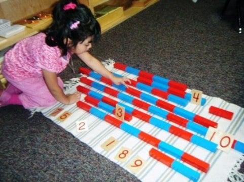 Child working with Montessori number rods