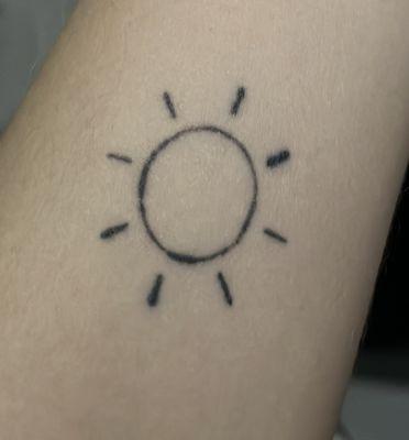 Outline tattoo of a sun