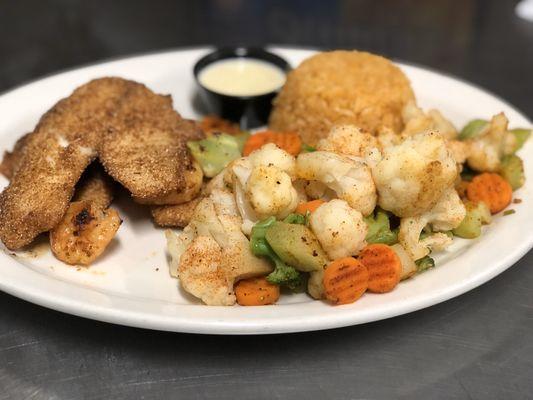 Stuffed Fish- Breaded Fish Stuffed with Shrimp and Covered in Cheese. Served with Steamed Veggies and Mexican Rice.