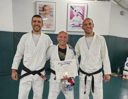 Coach Carlos Leal receiving his black belt from the Gracie Brothers.