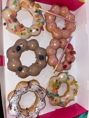 Opening day Mochi donuts. Blueberry, strawberry, milk pebbles, raspberry funnel cake, not shown Chocolate churro.