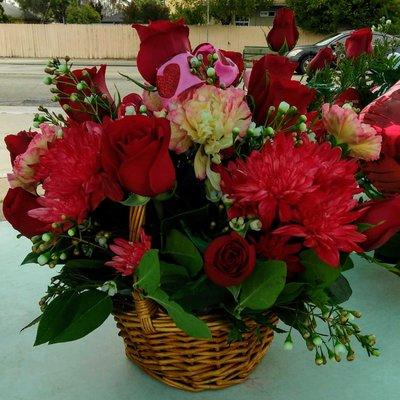 $59.99. A basket with Color red flowers and 12 red roses with a red bow. Great for Valentines.