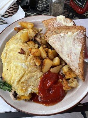 Omelette with spinach and mushroom, home fries, wheat toast