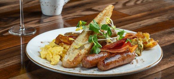 Delano Breakfast - two farm eggs your way, applewood-smoked bacon, pork sausage, smashed fingerling potatoes, baguette