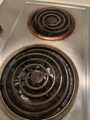 Dirty and greasy cooktop. Probably never cleaned