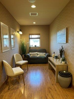 Our seated waiting area, where you can catch a grounding breath next to our bubbling fountain before your appointment.