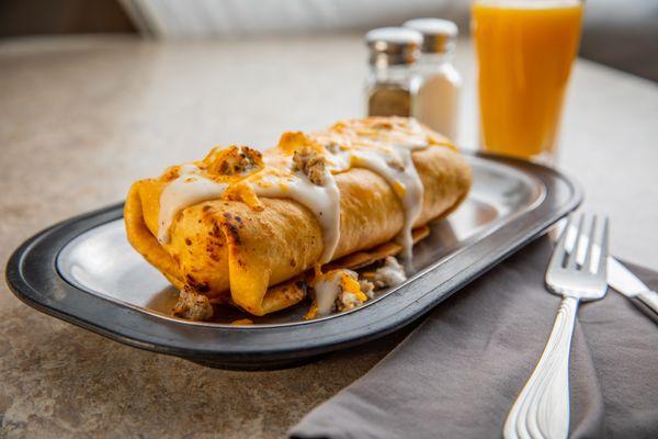 Breakfast Chimi--
Ham, bacon, sausage, scrambled eggs, hash browns, cheddar, bell peppers, and onions wrapped in a flour tortilla and dee