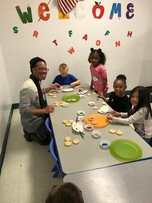 Some of our kindergarten children decorating cookies for Santa's visit tomorrow!