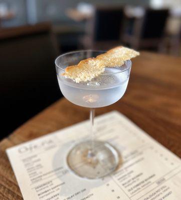 Stemware at Dolores: Four Pillars Olive Leaf Gin w/ olive brine, vinegar oil, salt & vinegar focaccia chip | $16 (requested no olive brine)