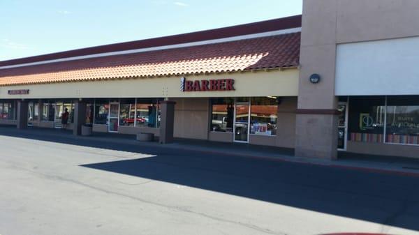 Out front of the barber shop