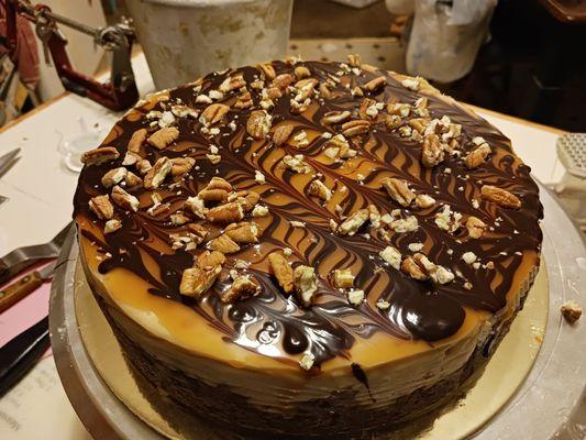 Turtle cheesecake with Carmel and chocolate drizzle with pecans