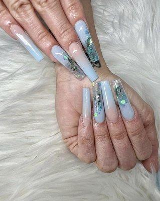 Gel X long coffin nails with turquoise holographic glitter.