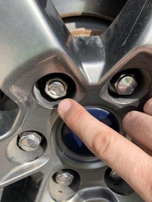 One of several damaged lug nuts.