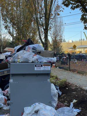 Kids play near overflowing garbage