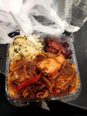 Fricassee chicken with jollof rice, cabbage and plantains.