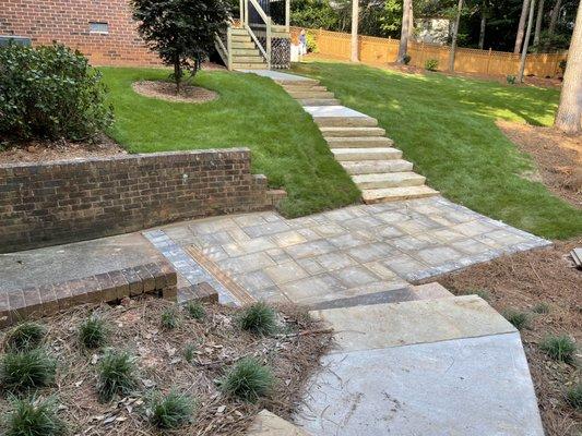 Zeon zoysia sod with flagstone steps and concrete walkway. You can also see the privacy fence we installed a few months ago.