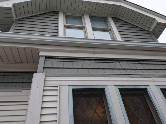 Siding falling off the house; example of the improperly installed lower trim piece.