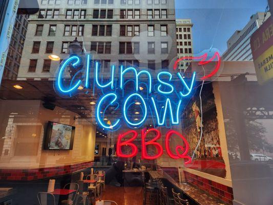 The front window of Clumsy Cow BBQ