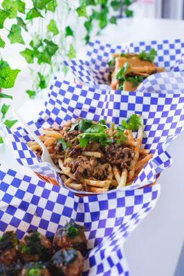 Viet fries - large portion of fries topped with grilled pork belly, onions, cilantro, and our house sauce