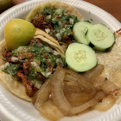 Two tacos al pastor  and mulas. Like the side of grilled onions and sliced cucumbers. Their salsas (verde and rojo) and good and spicy.