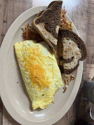 Corned beef hash omelette with hash browns and rye toast