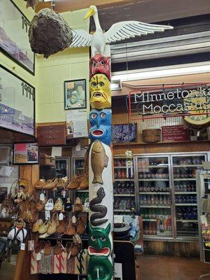 The totem pole is now inside the store.  Go in and talk to the owner!