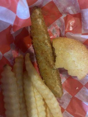 What's left of the fried pickles some fries And a piece of cornbread