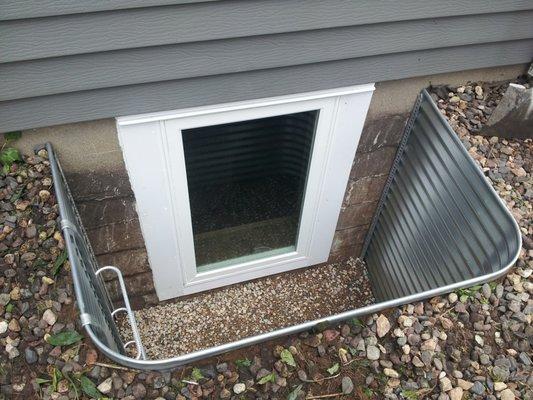 Egress window with metal window well, and ladder