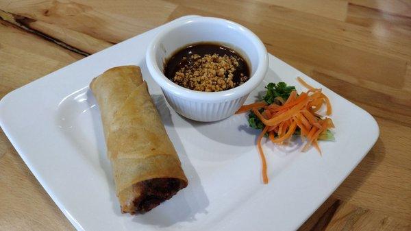 Egg roll with peanut sauce.