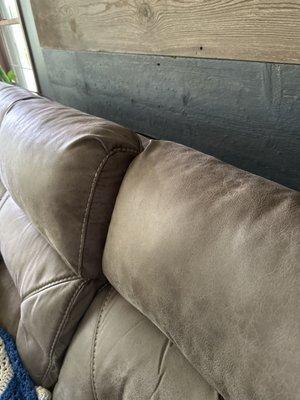 The sofa back doesn't come all the way up after their "professional" repair.