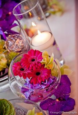 Transition from day to evening with bright Gerbera daisies and votive candles