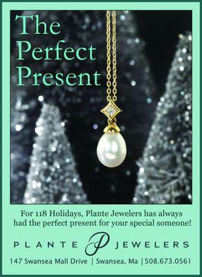 An ad title The Perfect Present, showing a pearl and diamond pendant.