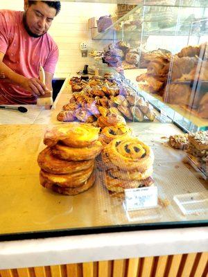 Counter of great looking pastries made according to the art of artisan baking, raisin croissants