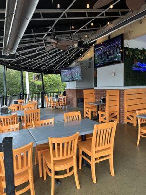 Outdoor seating. Lots of TVs.