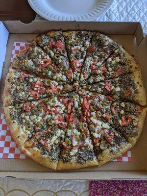 Za'atar pie with olives, tomatoes, and feta cheese