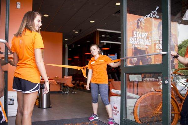 Emily and Mikayla get ready for the orange ribbon cutting at Grand Opening