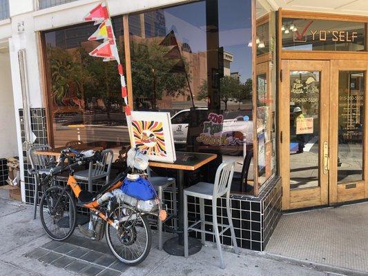 Exterior: My eBikeKit-assisted CruzBike parked alongside chairs  on Stanton street