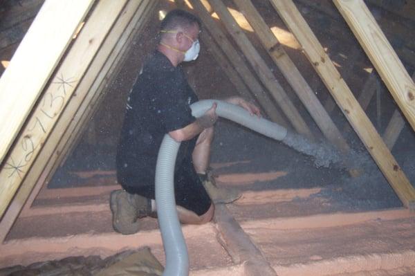 Blowing cellulose into an attic after doing a closed cell down spray on the attic floor...