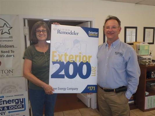 Owners Pat & John proudly display our Qualified Remodelor Top 200 Exterior Contractor Award.