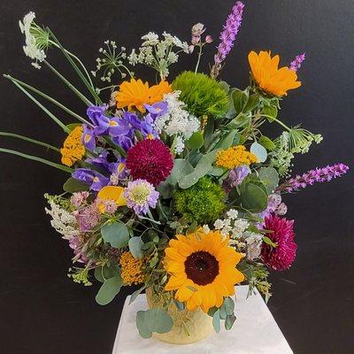 Blooms, blooms and more blooms arranged beautifully to say you're thinking of them.