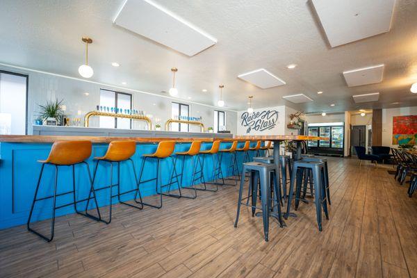 Interior with artisan crafted tap handles, bar top, and local art